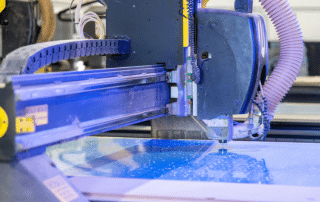 close up of a cnc machine wokring on plastic parts