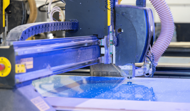 close up of a cnc machine wokring on plastic parts